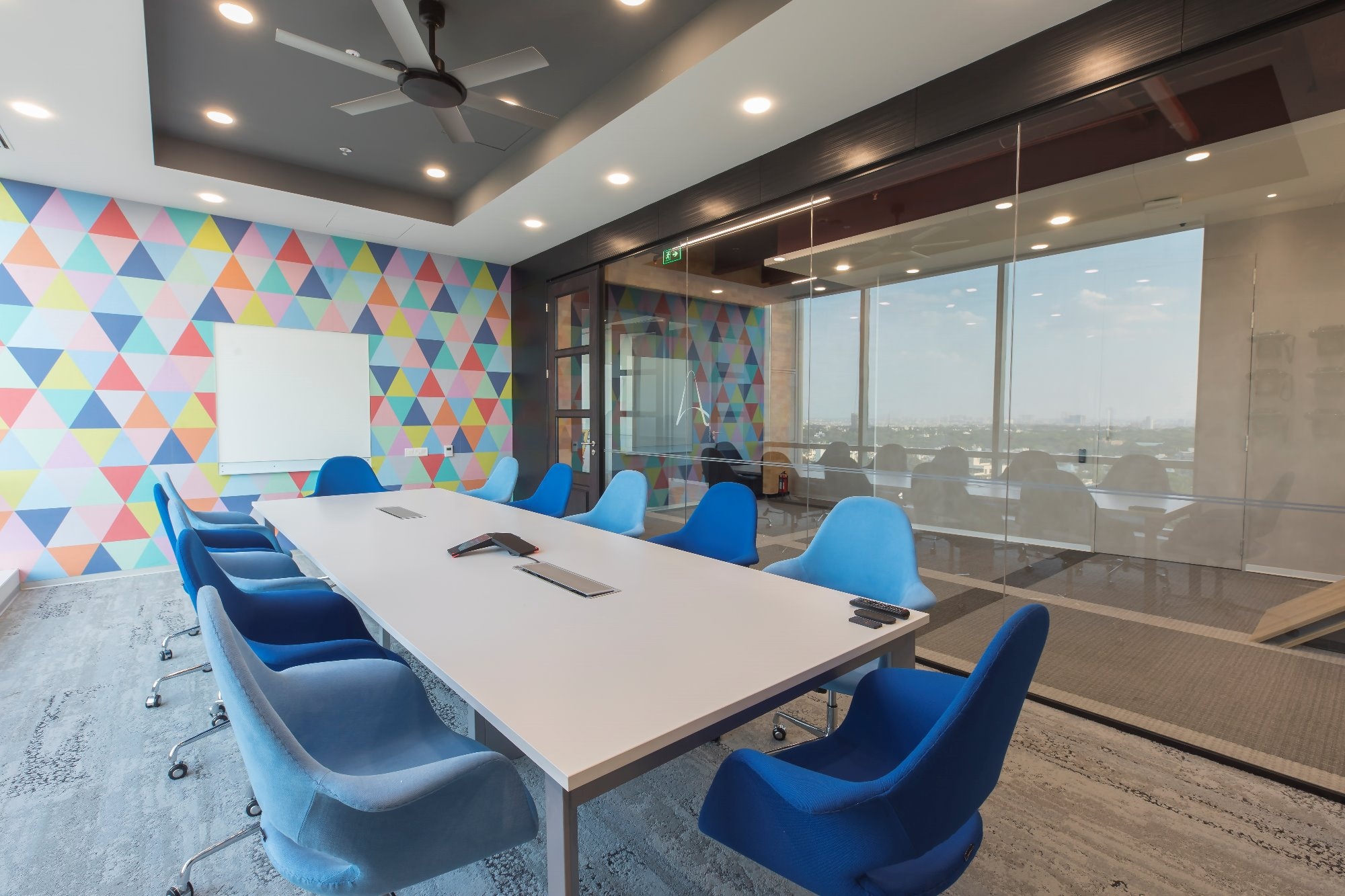 A meeting room with colorful elements and a glass partition