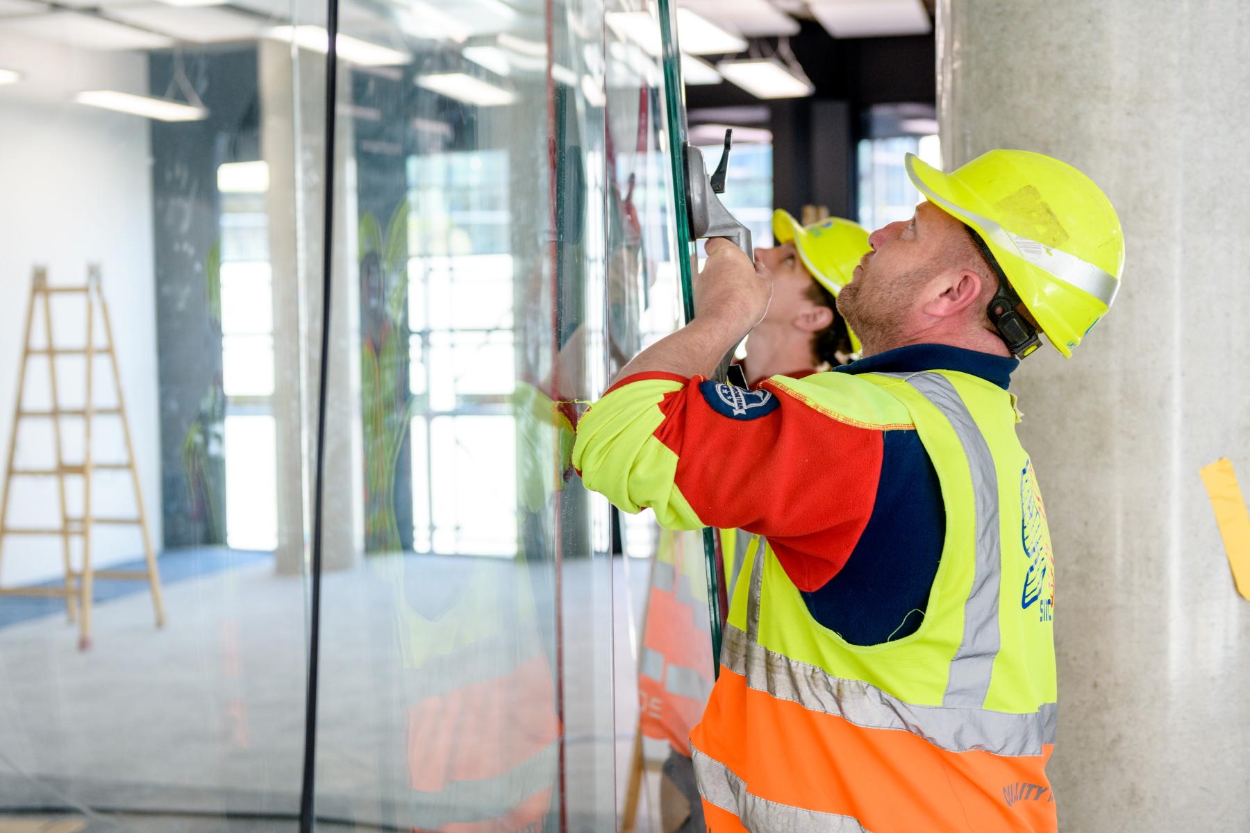 Fitters install partitions in the interior of a building in Ostrava.